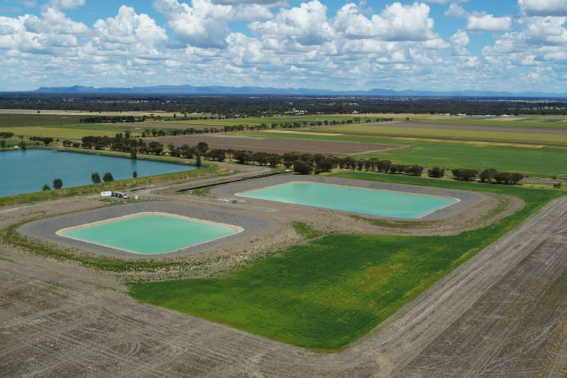 two aqua coloured dams and a blue dam at the Horsham SmartFarm, with clouds in a blue sky overhead  